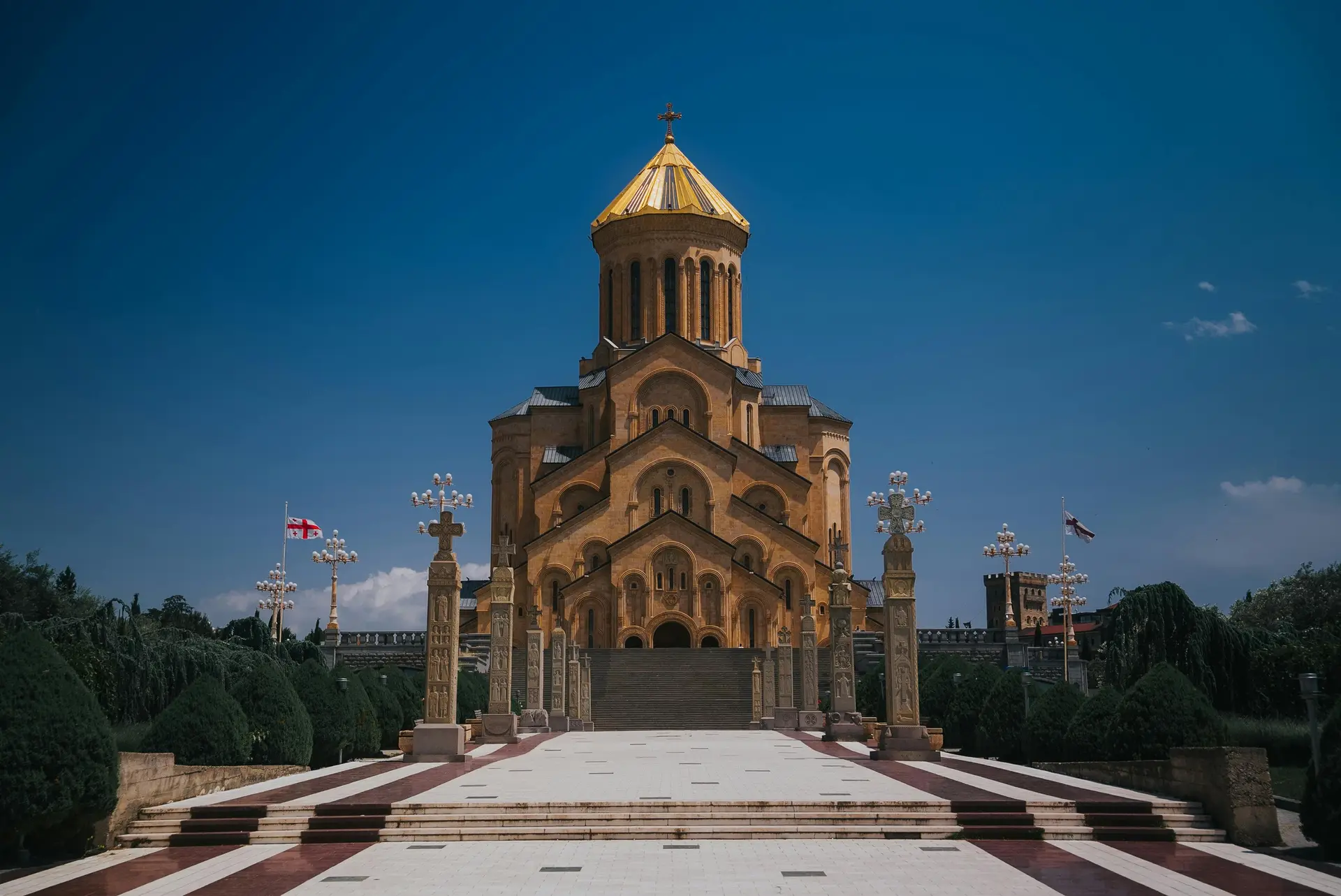 Sameba Cathedral in Tbilisi, Georgia against a clear blue sky